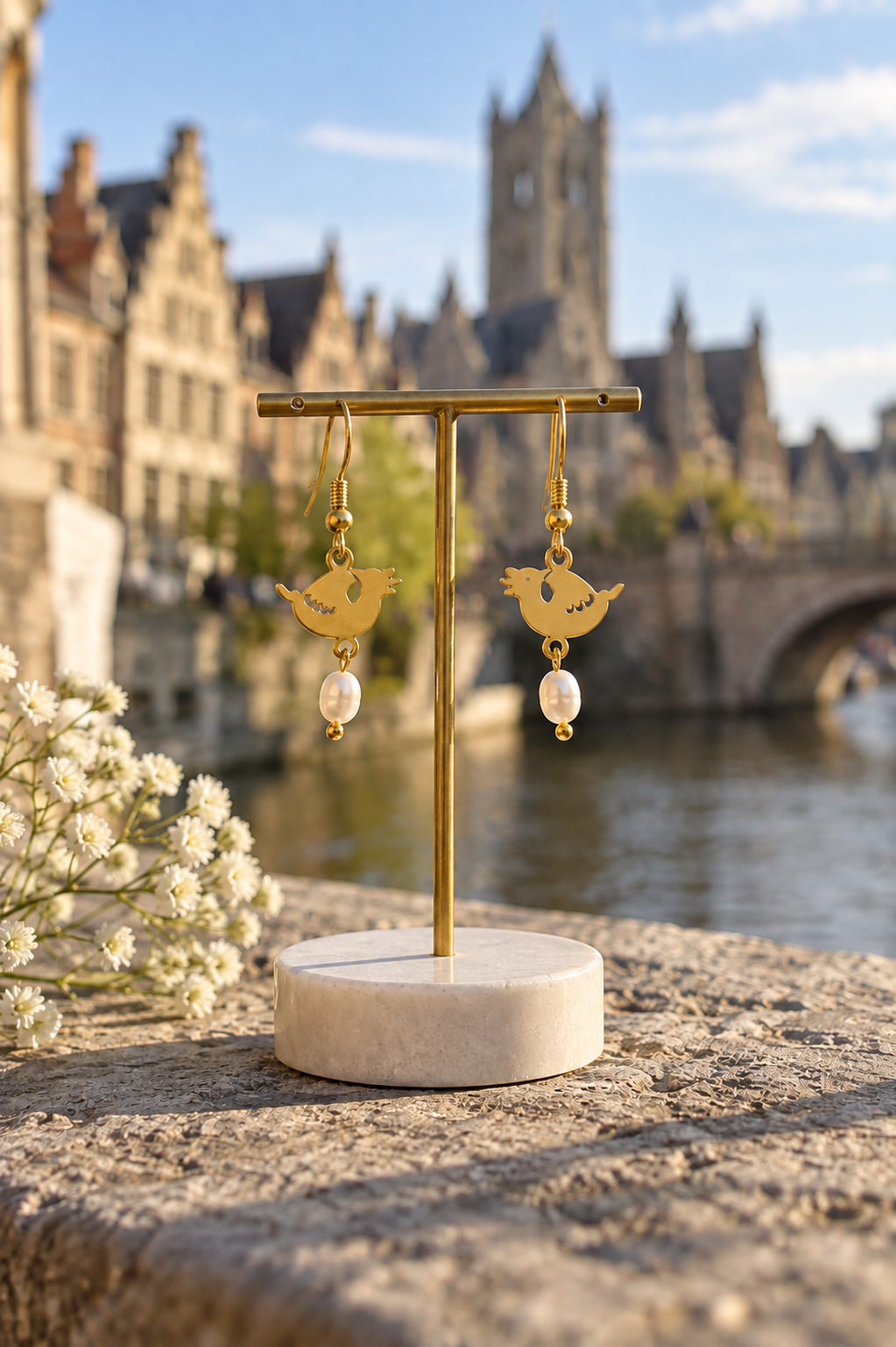 Dragon & Pearl Gold earrings by Van Gent Studio photographed outdoors in Ghent