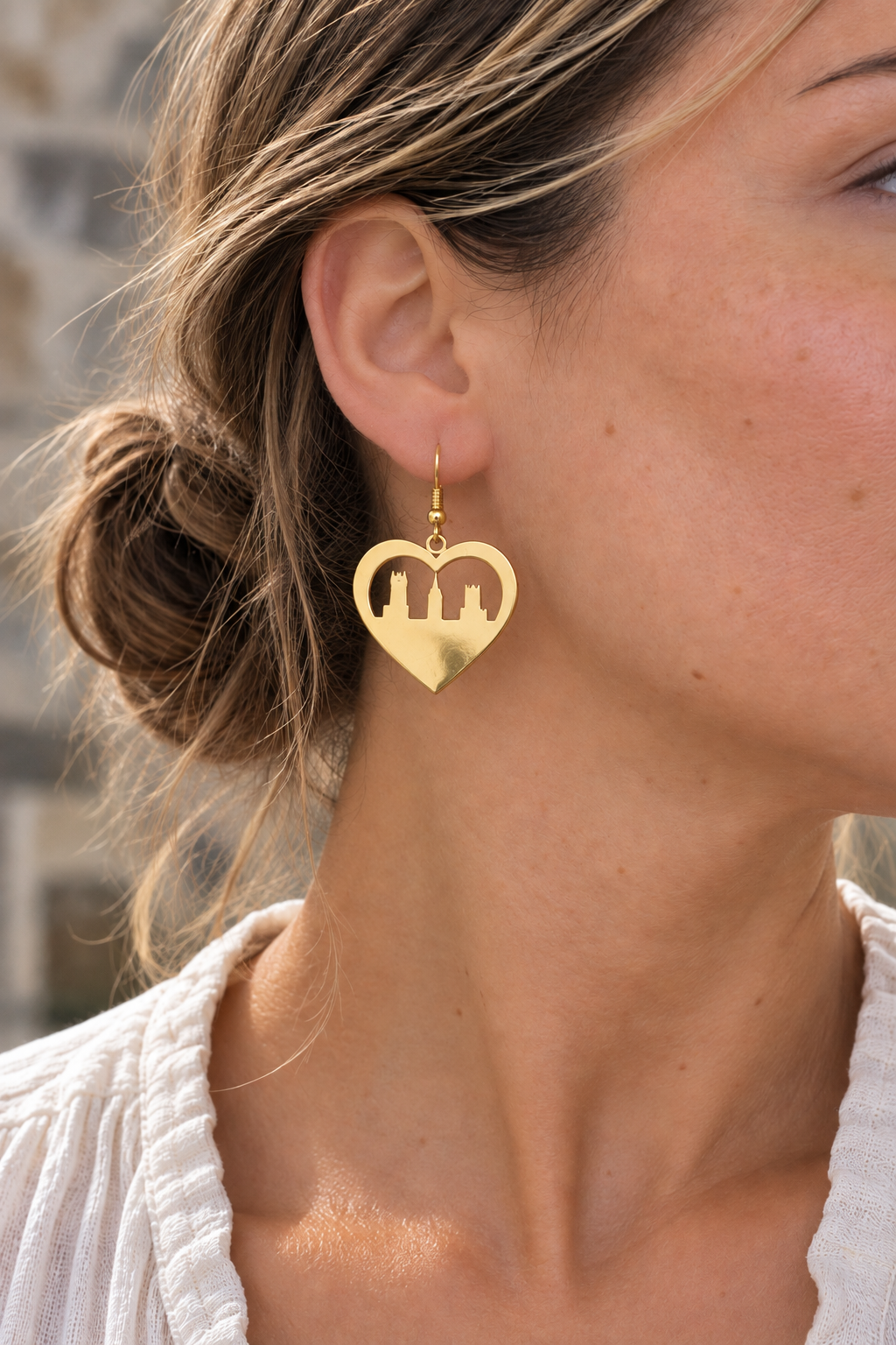 Model wearing Heart Skyline Earrings Gold by Van Gent Studio