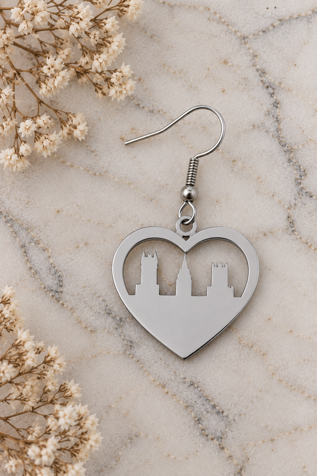 Heart Skyline Earrings Silver by Van Gent Studio on light marble with dried flowers